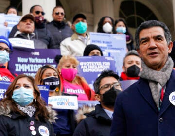 A councilmember speaks in front of a crowd of people in New York City.