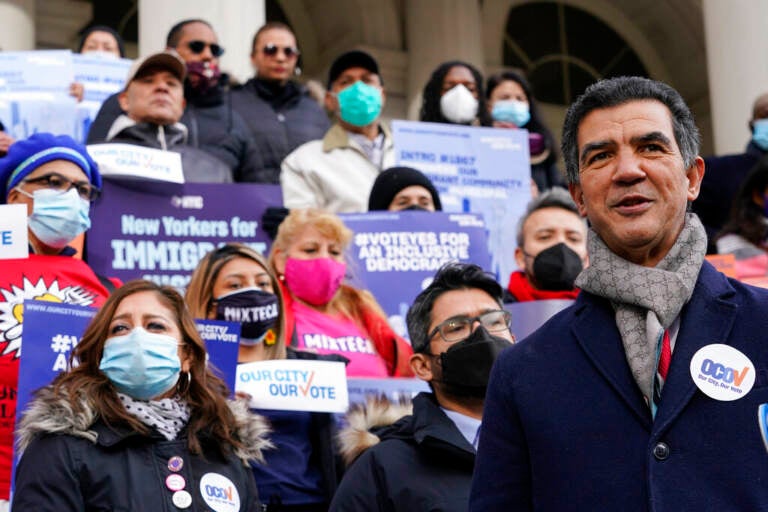 A councilmember speaks in front of a crowd of people in New York City.