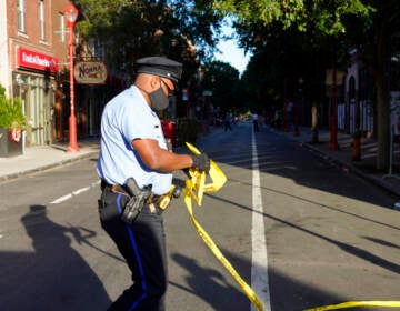 Philadelphia Police investigators work the scene of a fatal overnight shooting on South Street in Philadelphia, Sunday, June 5, 2022.