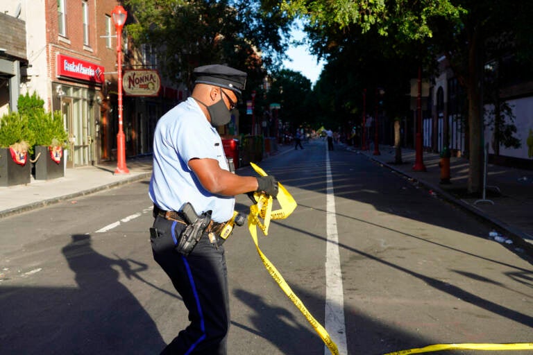 Philadelphia Police investigators work the scene of a fatal overnight shooting on South Street in Philadelphia, Sunday, June 5, 2022.