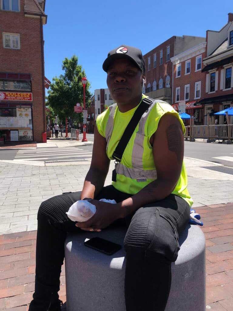 Sabrina Leftie, a sanitation worker, sits down outdoors on South Street.