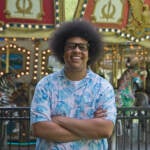 Cory Sharber stands in front of a carousel