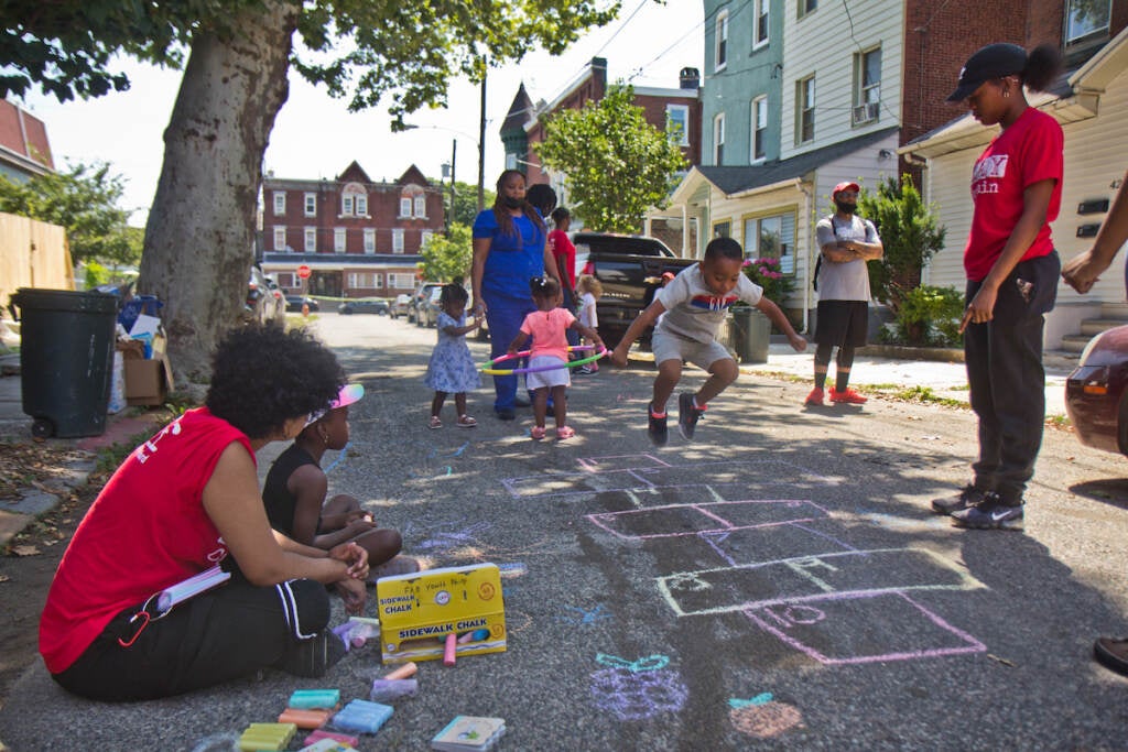 Play Streets’ Play Captains facilitate a game of hop scotch on Otter Street in West Philadelphia, on the program’s first day.