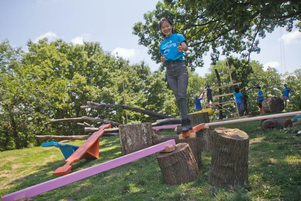 Janine Wang tests balance beams built by community members at FDR Park