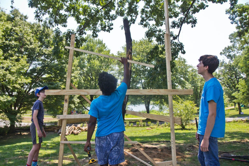 Community volunteers work to construct a play space at FDR Park in South Philadelphia