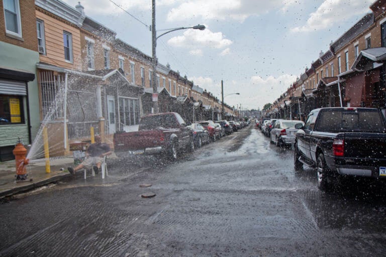 An open fire hydrant is pictured on Reese Street in Philly's Hunting Park neighborhood