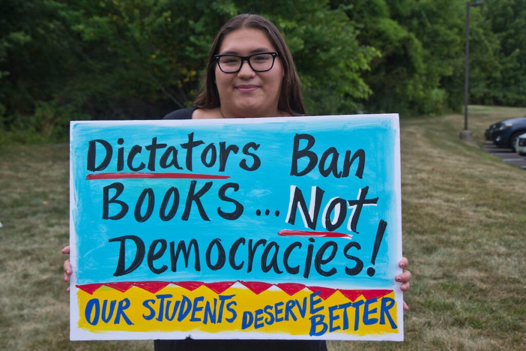 Michaela holds up a sign that says ''Dictators ban books ... not democracies!''
