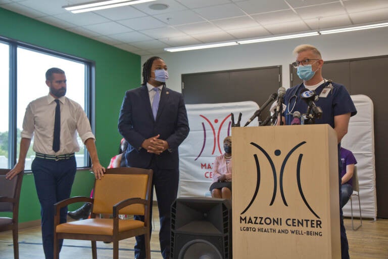 During a press conference Friday at the Mazzoni Center, Pa. State Representatives Brian Sims (left), and Malcolm Kenyatta (center), joined Mazzoni Center medical assistant Steven Roberston, who said the clinic's staff has not received enough vaccines to meet their patients' needs. (Kimberly Paynter/WHYY)