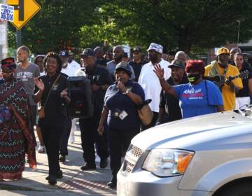 Police, religious and political leaders, and community members walk for peace in East Germantown. (Sam Searles/WHYY)