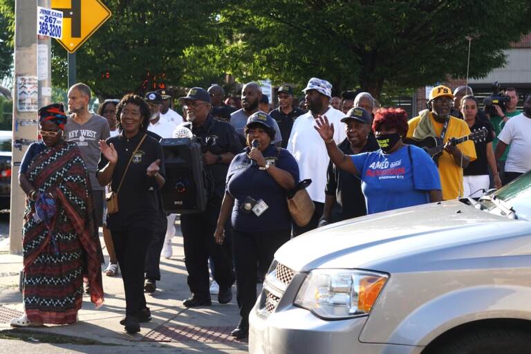 Police, religious and political leaders, and community members walk for peace in East Germantown. (Sam Searles/WHYY)