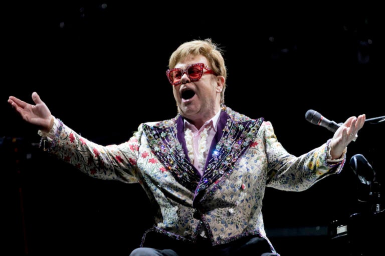 Elton John gestures during a performance