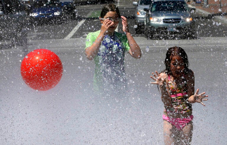 Children play in a fountain. Health officials say that the impacts of climate change, including more devastating wildfires, heatwaves, drought and poor air quality. (AP Photo/Don Ryan, File)