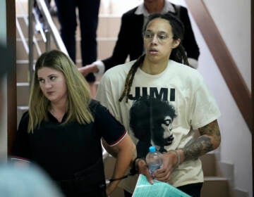 Brittney Griner is escorted to a courtroom for a hearing