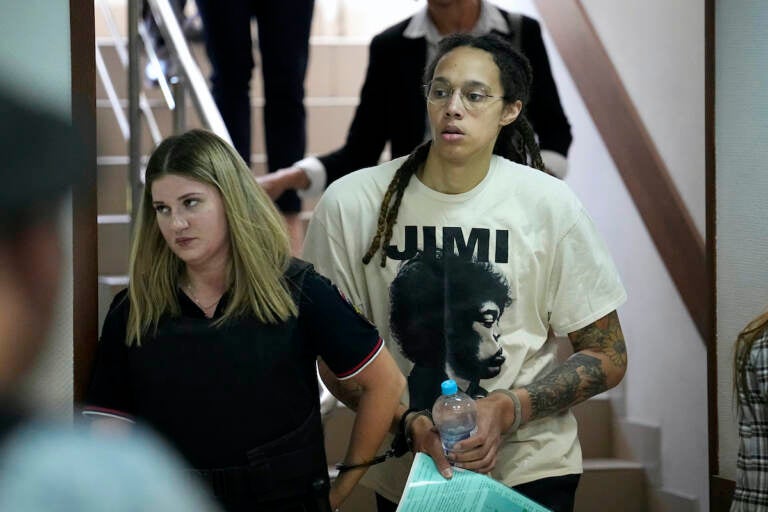 Brittney Griner is escorted to a courtroom for a hearing