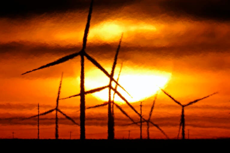 File photo: Wind turbines are silhouetted against the rising sun Wednesday, Jan. 13, 2021, near Spearville, Kan. (AP Photo/Charlie Riedel, File)