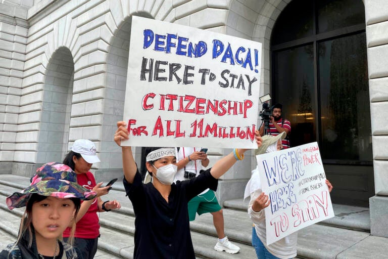 Demonstrators hold up signs outside the 5th U.S. Circuit Court of Appeals building in New Orleans on Wednesday, July 6, 2022. (AP Photo/Kevin McGill)