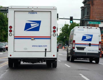 A USPS logo adorns the back doors of United States Postal Service delivery vehicles