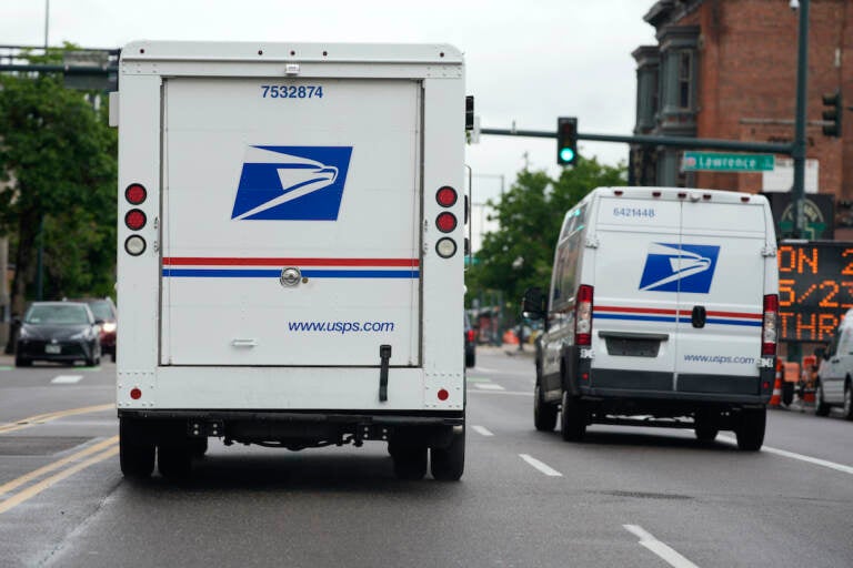 A USPS logo adorns the back doors of United States Postal Service delivery vehicles