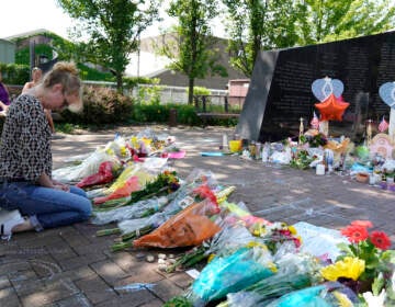 File photo: A visitor prays at a memorial to the seven people killed and others injured in the Fourth of July mass shooting at the Highland Park War Memorial in Highland Park, Ill., Thursday, July 7, 2022. (AP Photo/Nam Y. Huh, File)