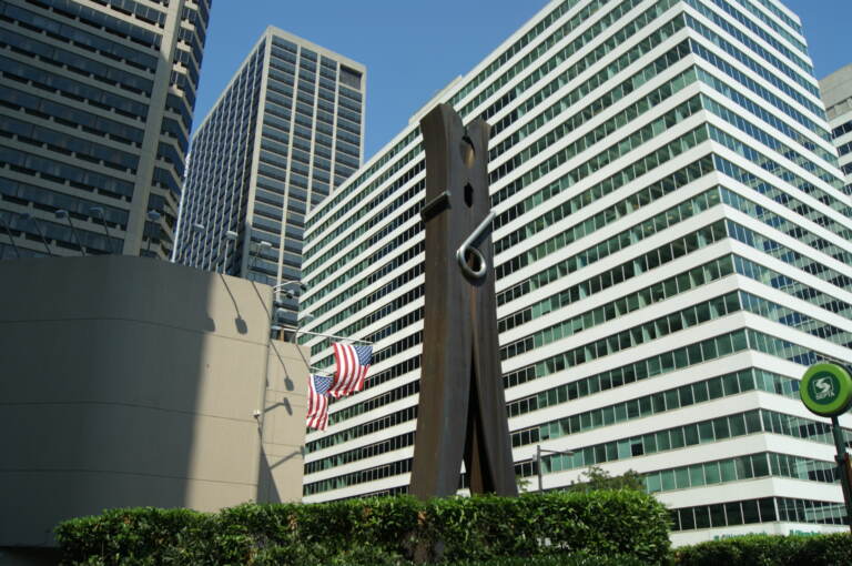 The Clothespin is visible, with buildings and the American flag in the background.