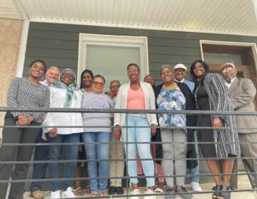 A groups stands in front of Ardella’s House transitional home for formerly incarcerated women located in the 2400 block of N 33rd street. (Cherri Gregg/WHYY)