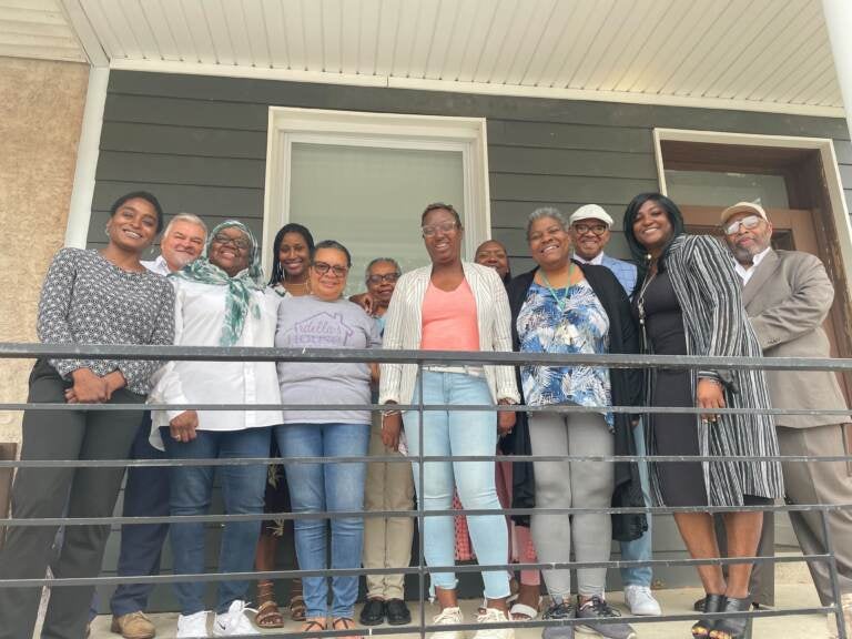 A groups stands in front of Ardella’s House transitional home for formerly incarcerated women located in the 2400 block of N 33rd street. (Cherri Gregg/WHYY)