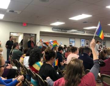 In May, 2022, Central Bucks parents raise pride flags in protest of the string of decisions made by administration and district leadership. (Emily Rizzo/WHYY)