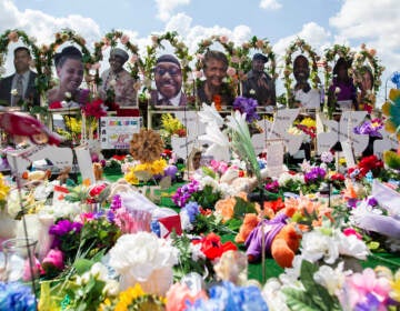 The white gunman who killed 10 Black people and injured three other individuals at a Tops supermarket in Buffalo, N.Y., in May was indicted by a federal grand jury on Thursday on hate crimes and firearm charges. Here, a memorial for the supermarket shooting victims is set up outside Tops on July 14. (Joshua Bessex/AP)