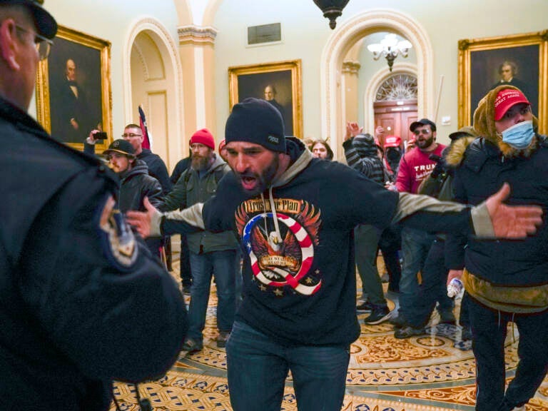 The congressional committee investigating the Jan. 6, 2021 attack on the Capitol will focus on the role of QAnon and extremist groups like the Oath Keepers and Proud Boys in its upcoming hearing. Prosecutors have identified the man at the center of this photograph as a QAnon-supporter named Douglas Jensen. Jensen has pleaded not guilty to all charges. (Manuel Balce Ceneta/AP)