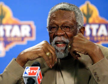 Up-close photo of Bill Russell speaking into a microphone.