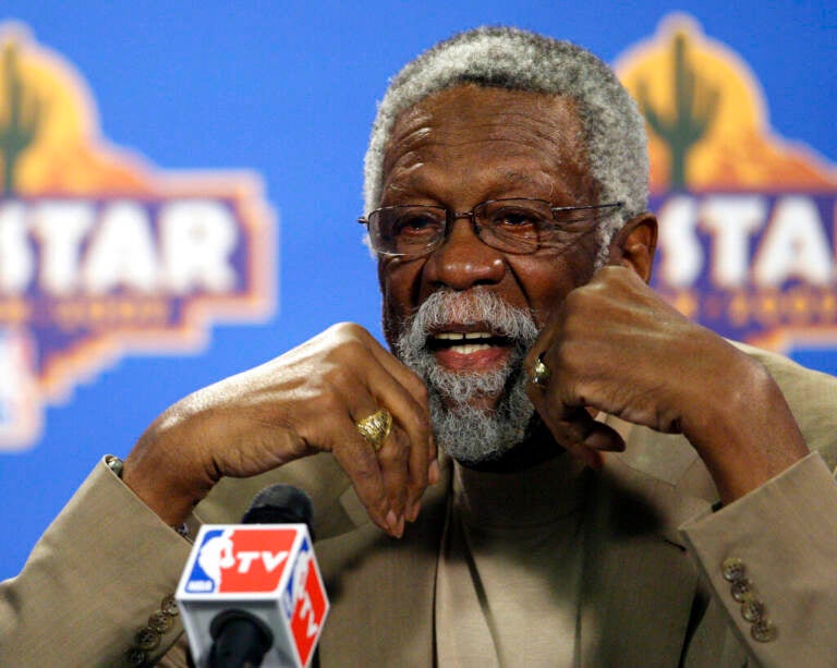 Up-close photo of Bill Russell speaking into a microphone.