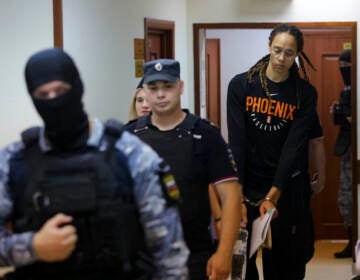 WNBA star and two-time Olympic gold medalist Brittney Griner is escorted to a courtroom for a hearing, in Khimki just outside Moscow, Russia, Wednesday, July 27, 2022. (Evgenia Novozhenina/Pool Photo via AP)