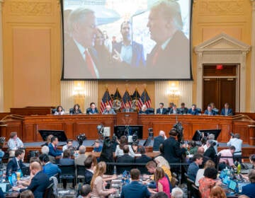 The Jan. 6 commission presents evidence below a screen which shows former President Donald Trump speaking with his Chief of Staff Mark Meadows.