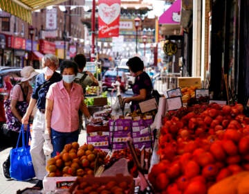 Customers shop for produce in Chinatown
