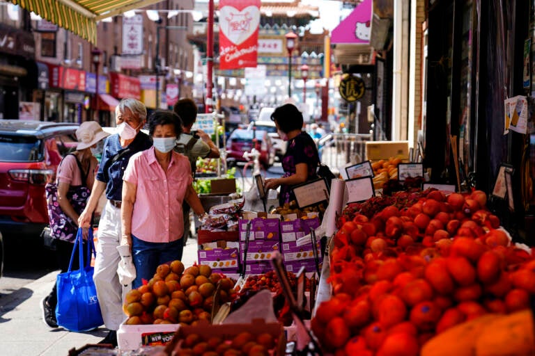 Customers shop for produce in Chinatown