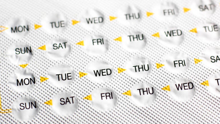 A view of birth control pills in a packet, marked by days of the week