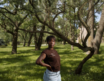 Brittany Mostiller poses for a portrait underneath a tree