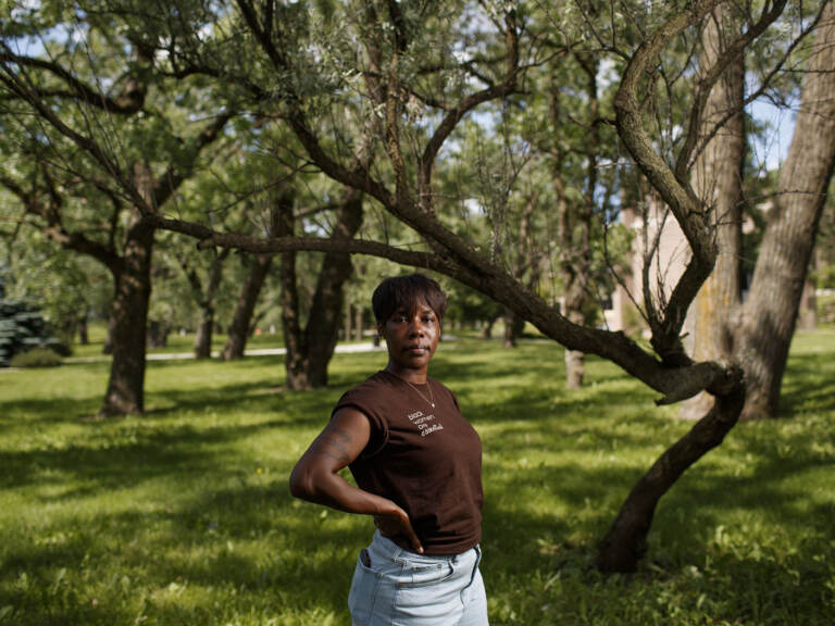 Brittany Mostiller poses for a portrait underneath a tree