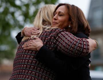 Vice President Kamala Harris hugs Highland Park, Ill., Mayor Nancy Rotering on Tuesday as she visits the site of Monday's mass shooting that killed seven people and injured dozens. (Kamil Krzaczynski/AFP via Getty Images)