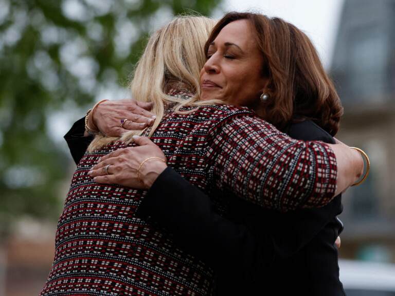 Vice President Kamala Harris hugs Highland Park, Ill., Mayor Nancy Rotering on Tuesday as she visits the site of Monday's mass shooting that killed seven people and injured dozens. (Kamil Krzaczynski/AFP via Getty Images)