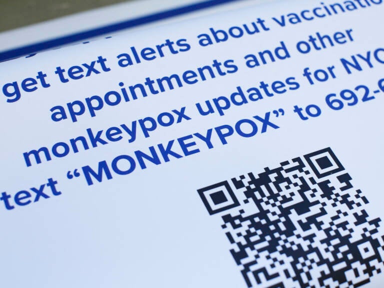 Informational posters are displayed at a monkeypox mass vaccination site