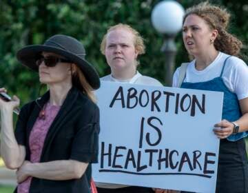 A person holds a sign that says, ''Abortion is health care'' at a rally at the Minnesota State Capitol