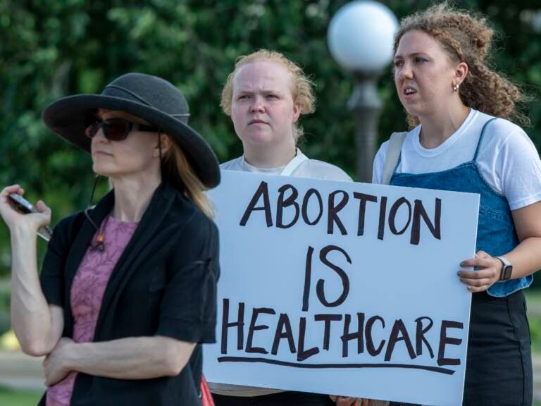 A person holds a sign that says, ''Abortion is health care'' at a rally at the Minnesota State Capitol
