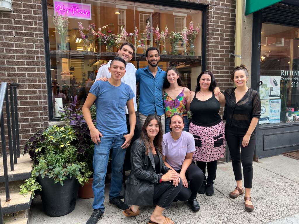 People gather in front of a restaurant called Her Place Supper Club.