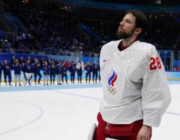 Ivan Fedotov receiving a silver medal at the 2022 Winter Olympics in Beijing as the Russian goalkeeper. (Matt Slocum/AP Photo)