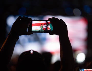 A performer is seen on the phone screen of a spectator of Philly's Wawa Welcome America July 4th concert