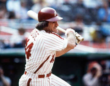 Pete Rose swings a bat.