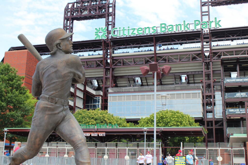 A statue is in the foreground, with Citizens Bank Park visible in the background.