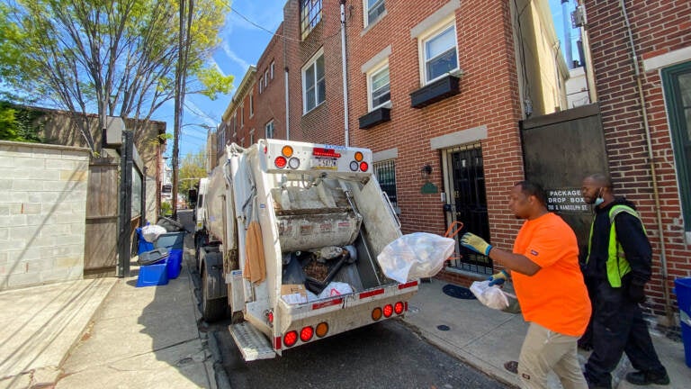 Streets Department workers pick up residents' trash