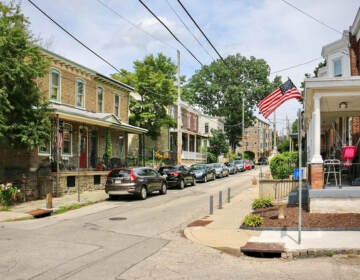 A view of a street with rowhomes on either side.